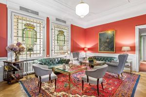 a living room with a couch and chairs and stained glass windows at Hotel Esplanade, BW Signature Collection in Stockholm