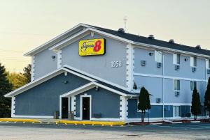 a large blue building with a sign for a store at Super 8 by Wyndham Benton Harbor St Joseph in Benton Harbor