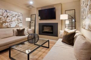 a living room with a couch and a fireplace at Seville Plaza Hotel, Trademark Collection by Wyndham in Kansas City