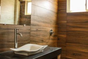 a bathroom with a sink and a mirror at Hostal Sky in Tarija