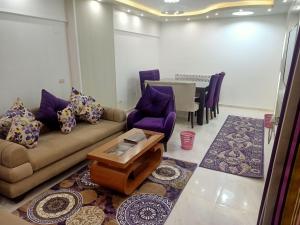 a living room with a couch and chairs and a table at للعائلات فقط the fardous apartment sea view in Alexandria