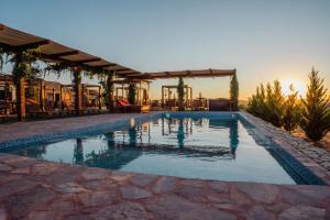 a swimming pool in the middle of a resort at Entrevalle Hotel Boutique in Valle de Guadalupe