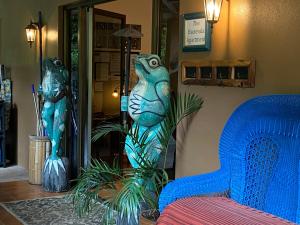 a room with a blue couch and two statues at The Garden Apartment at The Hacienda in Boquete