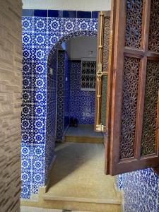 una puerta a una habitación con azulejos azules y una puerta en Riad Essalam en Rabat