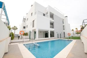 a building with a swimming pool in front of a building at Arenas de Sanlúcar in Sanlúcar de Barrameda +14 photos