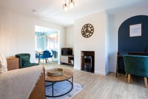 a living room with a couch and a fireplace at Stylish Railway Themed House - Central Warrington in Warrington