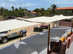 a tent is set up in a parking lot at Pousada Solar Maia Costa in Atins