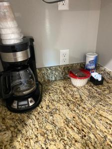a coffee maker on a counter with a cupcake at The Woods Lodging in Kingston