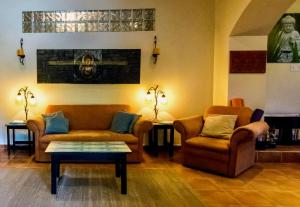 a living room with two couches and a table at The Garden Apartment at The Hacienda in Boquete