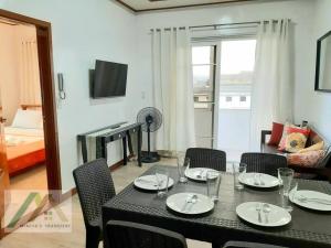 a dining table and chairs in a living room at Mireya's 1BR condo at Zone Vill - Burnham Park in Baguio