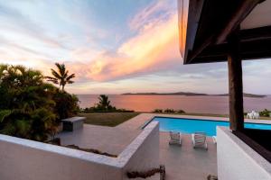 a villa with a swimming pool and a view of the ocean at Villa Vanua - Private Luxury Villa in Rakiraki