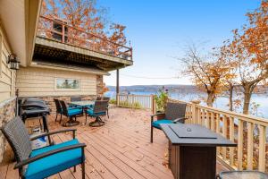 a deck with chairs and a table and a balcony at Live Laugh Lake in Rushville