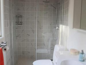 a bathroom with a shower with a toilet and a sink at 4 person holiday home in SKÅNES-FAGERHULT-By Traum in Slättsjö +20 photos