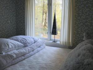 a bedroom with a bed in front of a window at 4 person holiday home in SKÅNES-FAGERHULT-By Traum in Slättsjö