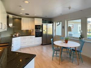 a kitchen with a table and chairs in a kitchen at Holiday home TORSLANDA III in Torslanda