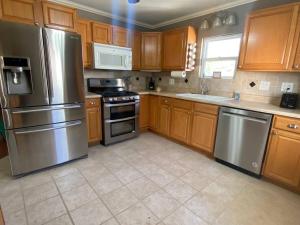 a kitchen with wooden cabinets and stainless steel appliances at 12 minutes to Palo Duro, 5 minutes to WT in Canyon