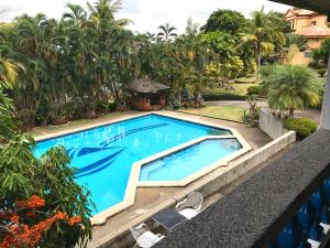 a swimming pool in the middle of a resort at Casa Las Brisas, Puerto Azul in Ternate