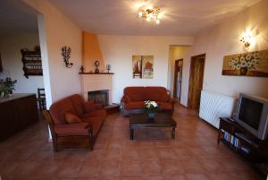 a living room with two couches and a tv at Villa villaeri in Skiathos