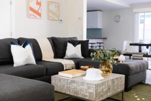 a living room with a couch and a coffee table at Indigo By AvantStay Sleek Charming Home 2 Blks from Bay w Hot Tub in San Diego