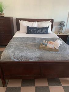 a bed with a tray with a sweet dreams pillow on it at Cozy Oceanview Studio w parking in San Juan