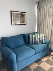 a blue couch sitting in a living room at Cozy Oceanview Studio w parking in San Juan