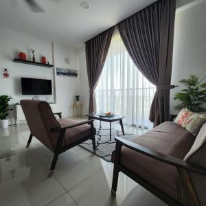 a living room with a couch and a chair and a tv at Casa Kayangan Ipoh 3 Bdrm condo Meru Ipoh 15mins to Sunway Onsen World of Tambun in Ipoh