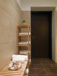 a room with a shelf with towels and a door at Kodaly Art Apartment in Budapest