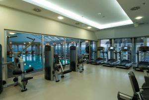 a gym with a swimming pool and treadmills at WOW Istanbul Hotel in Istanbul