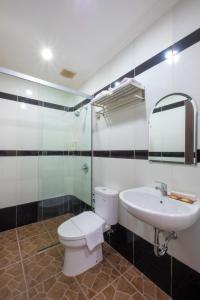 a bathroom with a toilet and a sink at Kelayang Beach Hotel in Tanjungbinga