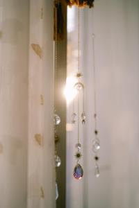 a group of ornaments hanging from a window at LáVuTa Home in Vung Tau