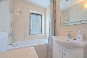 a bathroom with a sink and a bath tub and a sink at Apartments Lucija in Postira +34 photos