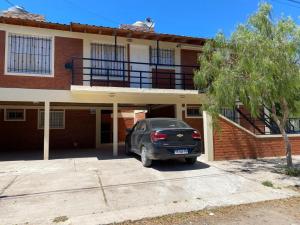 a car parked in a parking lot in front of a building at Complejo Anita 07 in Las Grutas