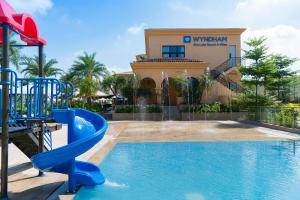 a pool at a resort with a slide at Wyndham Sky Lake Resort and Villas in Hanoi