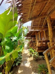 a bamboo house with a pathway leading to it at Jake and Zyra Place in San Vicente