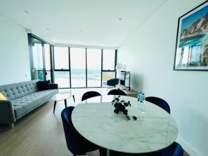 a living room with a table and a couch at New Luxury stunning water view 2bed2bath Condo in Sydney
