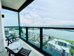 a balcony with a table and chairs and the ocean at New Luxury stunning water view 2bed2bath Condo in Sydney