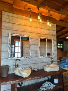 two sinks in a wooden room with two mirrors at Hotel Pousada Praia do Farol in Ilha do Mel