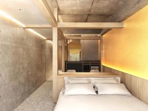 a bedroom with a bed and a yellow wall at Kyoto ITOYA Hotel Mon in Kyoto