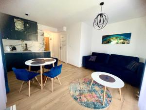 a living room with two tables and a couch at Apartament w Białce Tatrzańskiej in Białka Tatrzańska