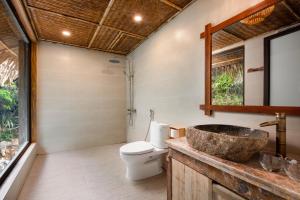 a bathroom with a sink and a toilet at Mường Village Ninh Bình in Ninh Binh