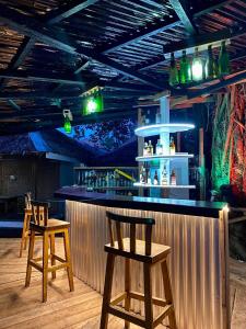 a bar with two wooden stools in a room at Hotel Sebastian Panglao in Bolod