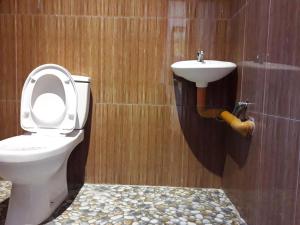 a bathroom with a toilet and a sink at Bearby's Homestay Siargao - RH in Catangnan