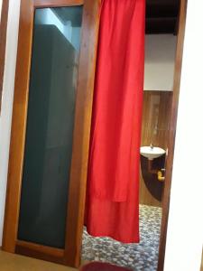 a door with a red curtain in a room at Bearby's Homestay Siargao - RH in Catangnan