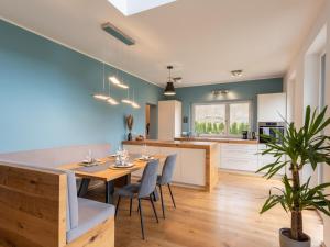 a kitchen and dining room with a table and chairs at Tasteful holiday home near Ossiacher lake in Töbring