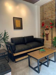 a living room with a couch and a coffee table at JORA LOFT- modern industrial apartment 1-A in Dagupan