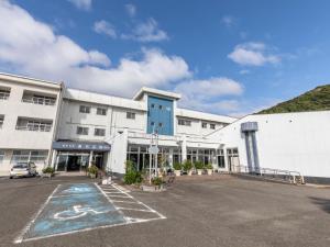 a building with a parking lot in front of it at Arafune Resort in Shimo-tahara