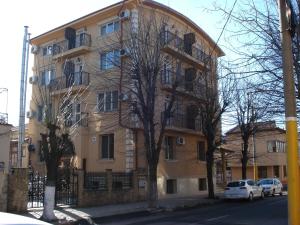 a large building with cars parked in front of it at Villa Edel Constanta in Constanţa