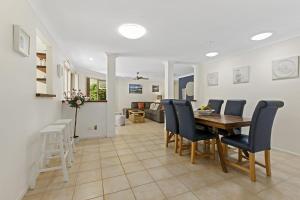 a dining room and living room with a table and chairs at 21 David Street Noosa Heads in Noosa Heads