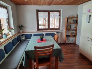 a dining room with a table and chairs at Bauernhaus im Permakultur-Garten in Sankt Johann in Tirol