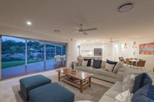 a living room with a couch and a table at 21 Wesley Court Noosa Sound in Noosa Heads